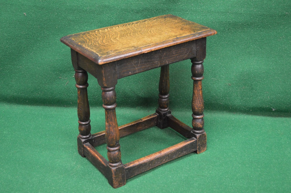 An oak joint stool having moulded top supported on turned legs leading to bottom stretcher and block