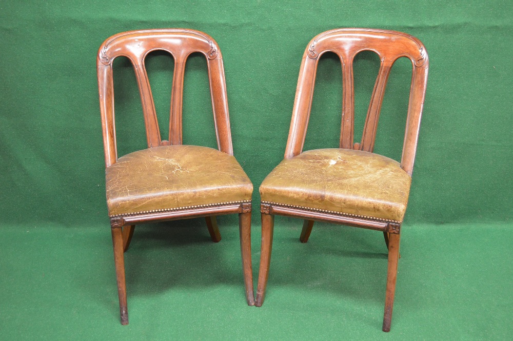 A set of six mahogany dining chairs having scroll carved decorated top rail supported by four