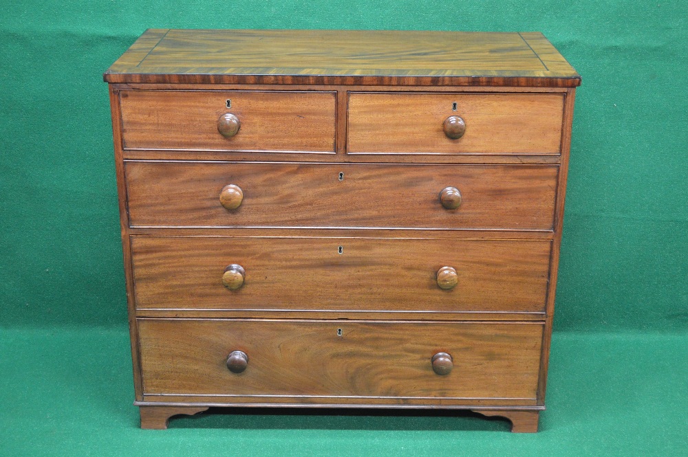 A mahogany chest of five drawers having cross banded top over two short and three long graduated
