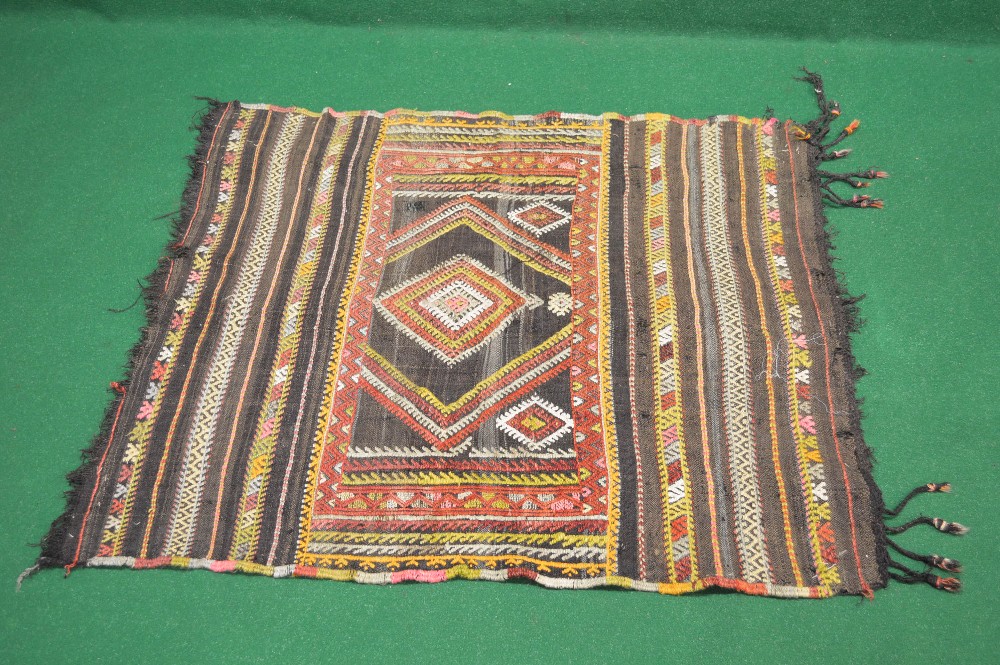 A brown ground rug decorated with red, yellow, white, orange and pink pattern - 45.5" x 39.5"