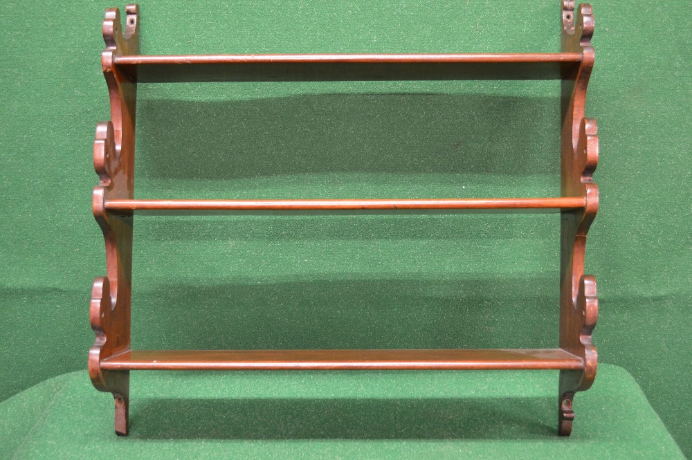 A set of mahogany wall shelves having shaped sides supporting three fixed shelves - 26" wide