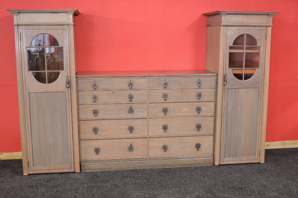 A Waring & Gillows Ltd Arts & Crafts limed oak gentleman's compactum wardrobe having inlaid