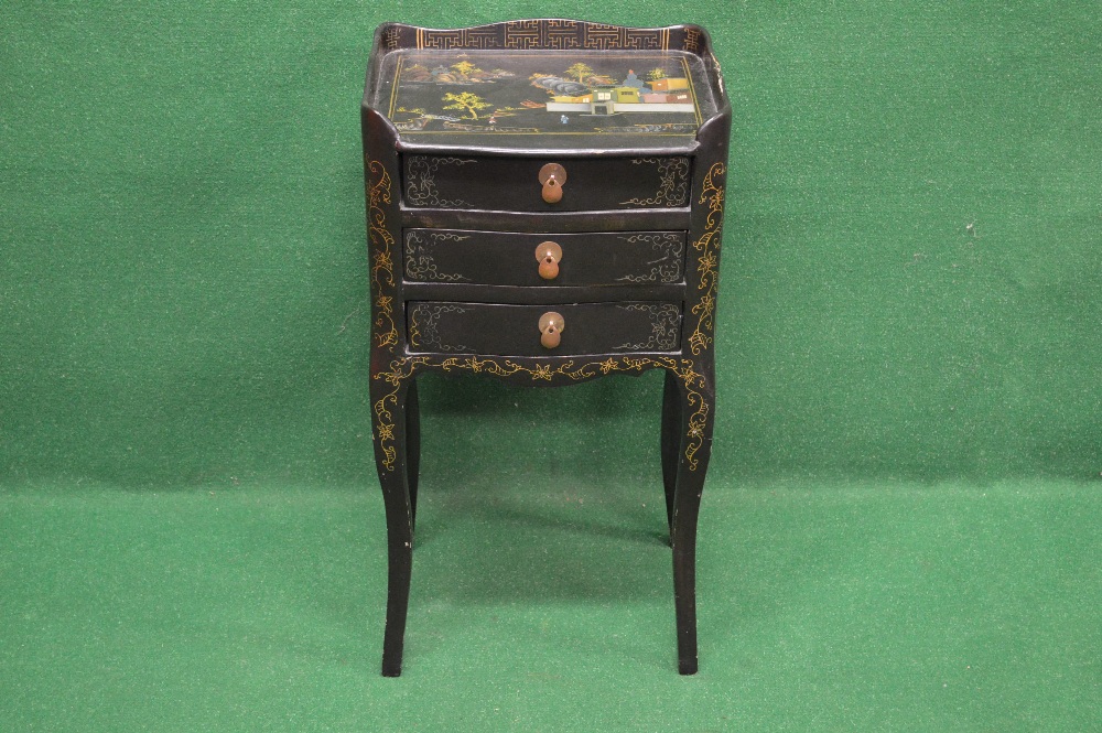 A black lacquered night stand having 3/4 raised gallery over three drawers with drop handles and