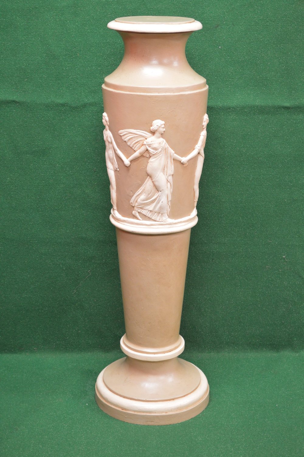 A plaster stand of urn form decorated with raised figures of ladies around the urn formed body,