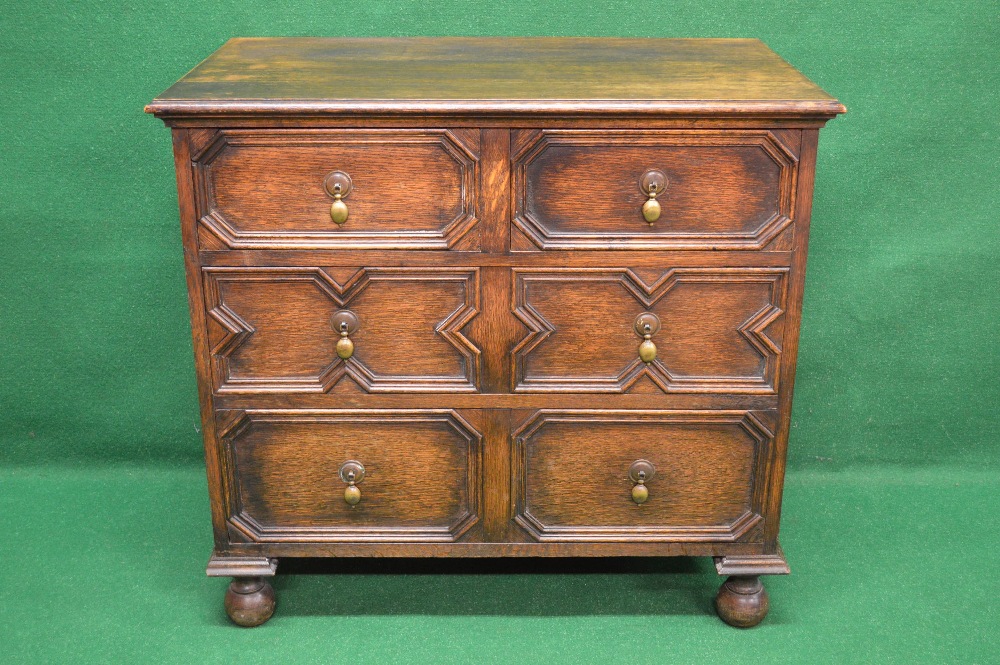 An oak Jacobean style chest of drawers having two short and two long drawers with brass handles