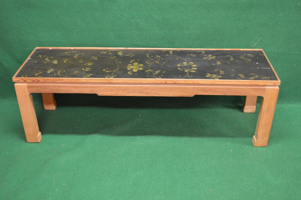 An 18th century lacquered panel top coffee table with later base decorated with gilt foliate