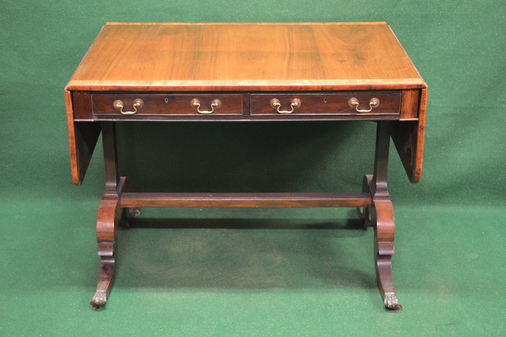 A rosewood sofa table having cross banded top and two drop flaps over two drawers with brass