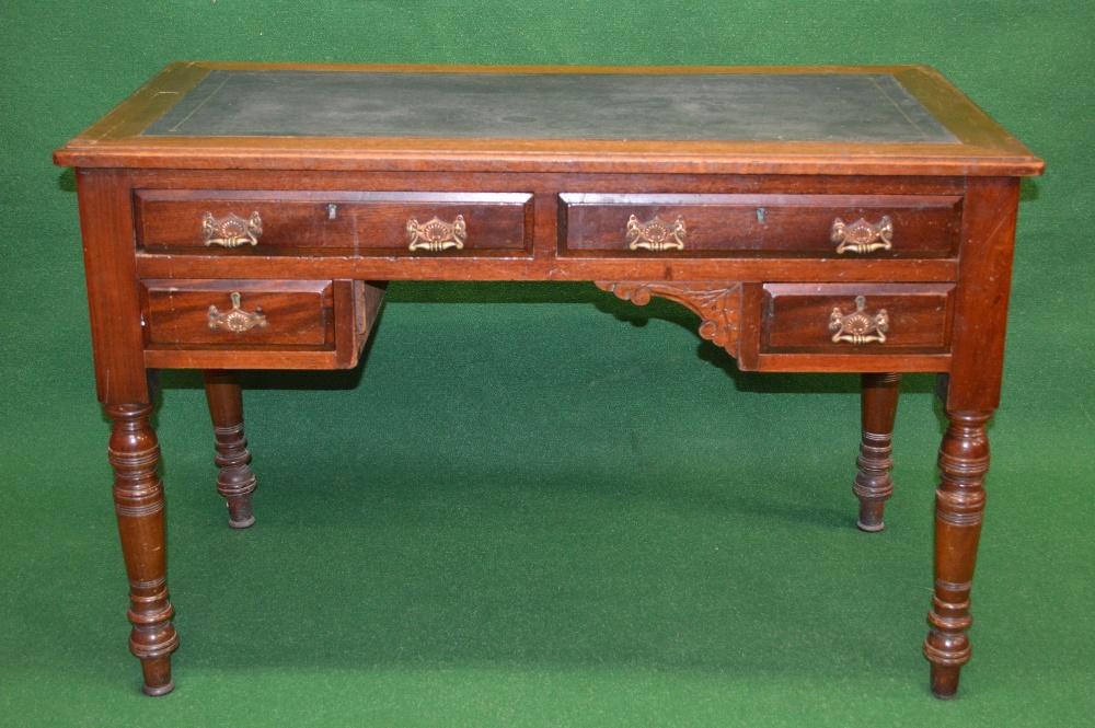 An Edwardian mahogany writing desk having black leather insert, the top having moulded edge over two