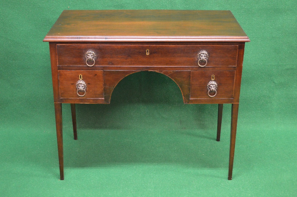 A mahogany writing table having moulded edge over single long drawer with arched kneehole flanked by