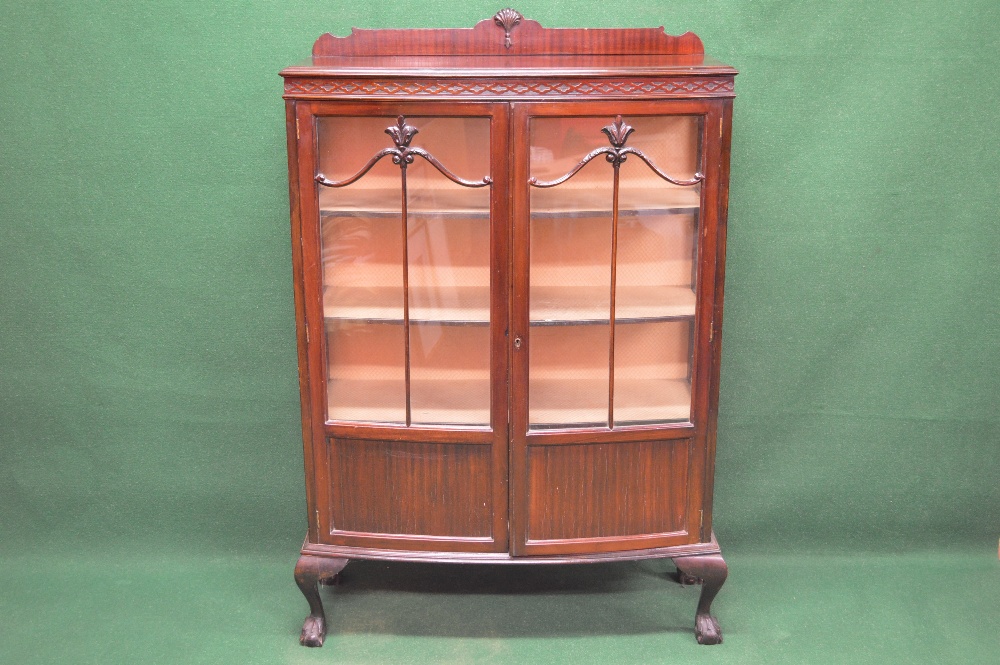 A mahogany bow fronted display cabinet having two glazed doors enclosing three fixed shelves and