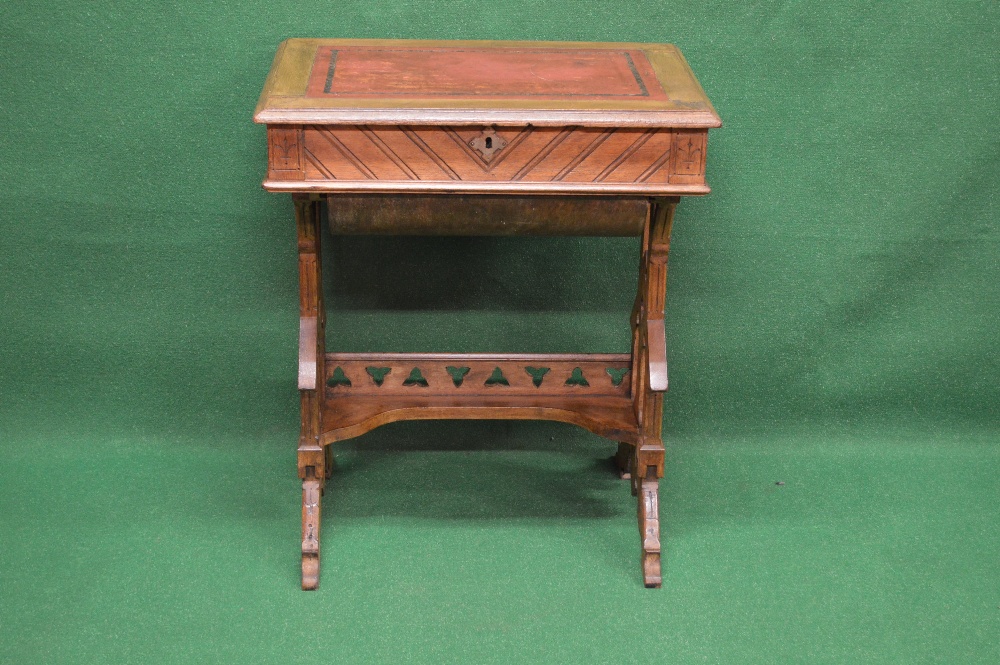 An oak Arts & Crafts work table having red leather insert with rising top opening to reveal