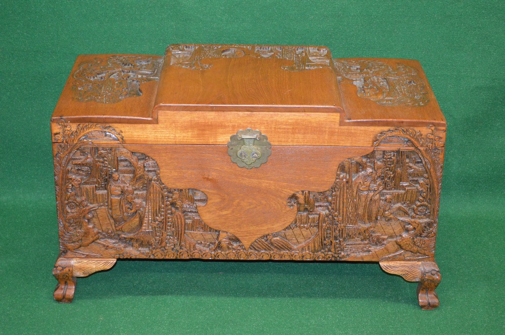 A carved camphor wood chest having stepped top with Oriental carvings, the front having matching