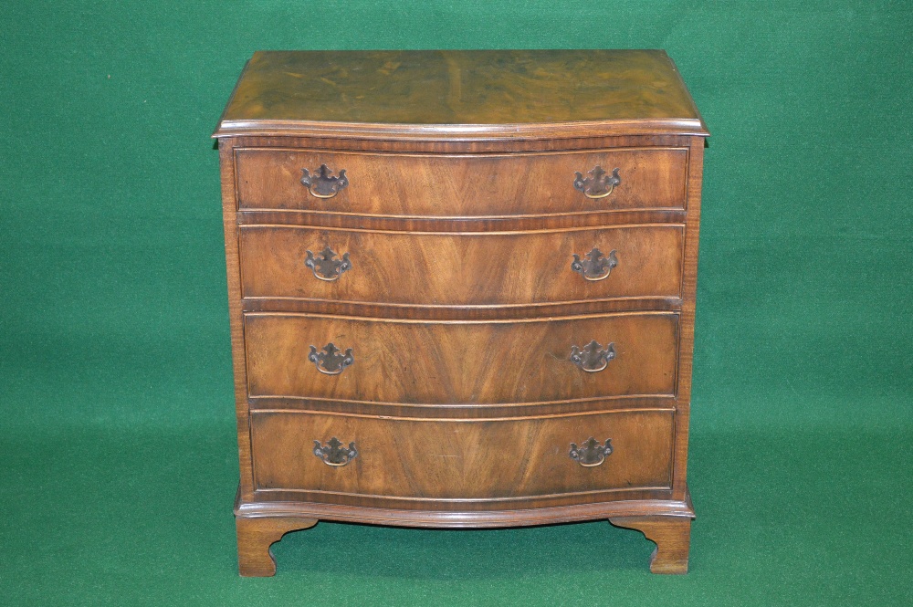 A 20th century walnut serpentine fronted chest of drawers having four long graduated drawers with