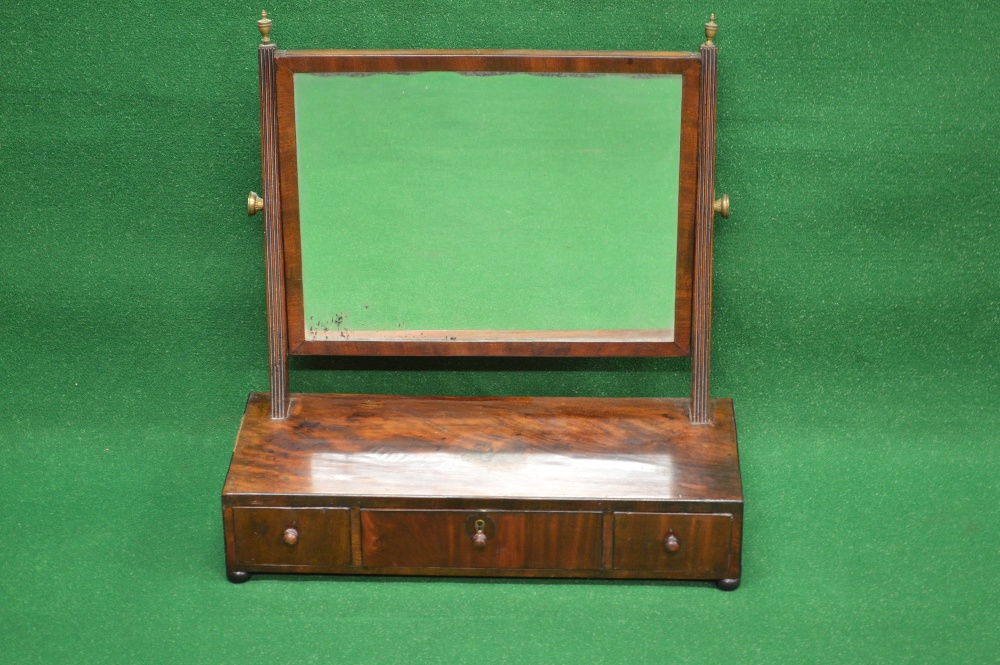 A mahogany swing frame drawer based mirror, reeded supports for the mirror leading to box base