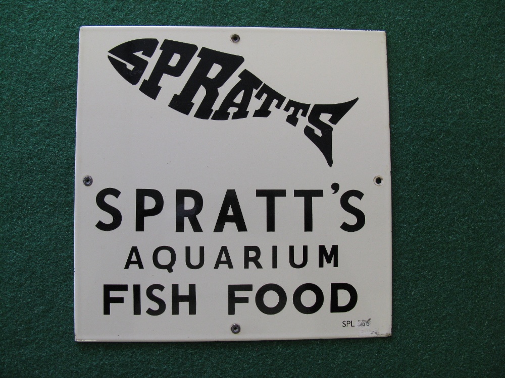A Spratts Aquarium Fish Food enamel advertising sign of black letters and fish on a white ground -