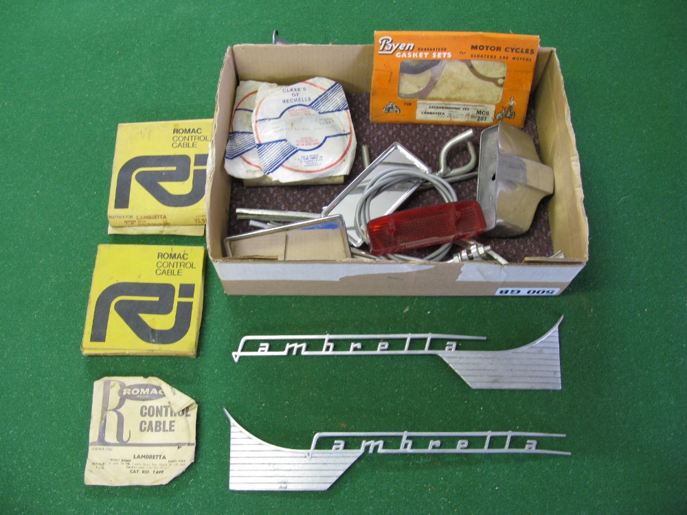 A box containing a quantity of Lambretta Li parts to include gasket set, control cables, mirrors,
