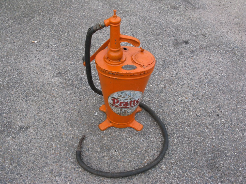 An original Pratts Motor Oil dispenser in orange livery with brass plaque inscribed Property of Esso