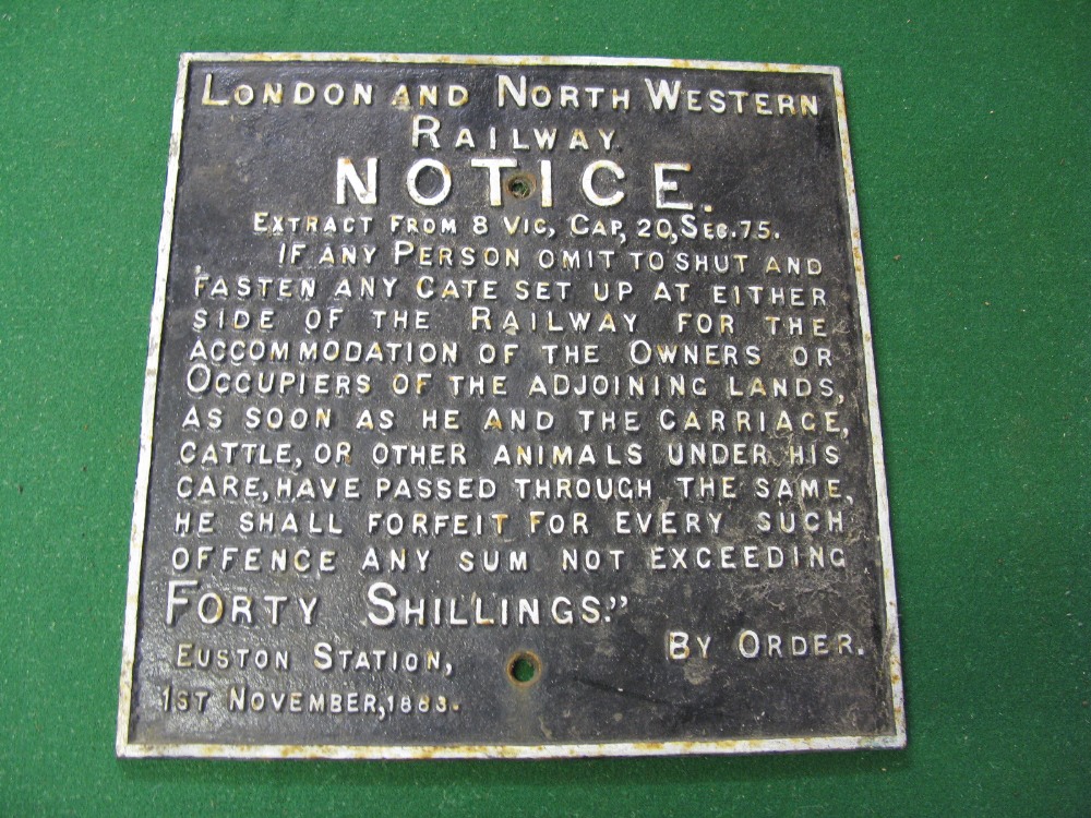 A cast iron London and North Western Railway notice stating that a person will be fined 40 shillings