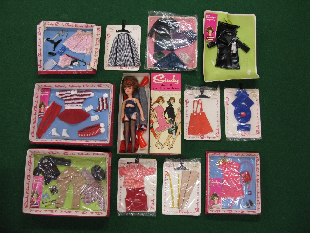 A quantity of Sindy clothing in tray and hanging packaging to include horse riding, skating and '