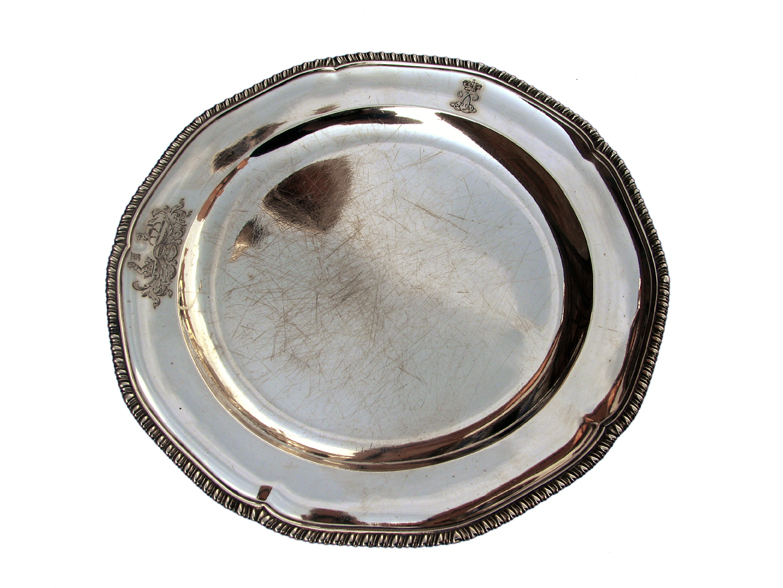 A fine set of 12 George IV silver dinner plates with wavy gadrooned rim. The engraving shows the