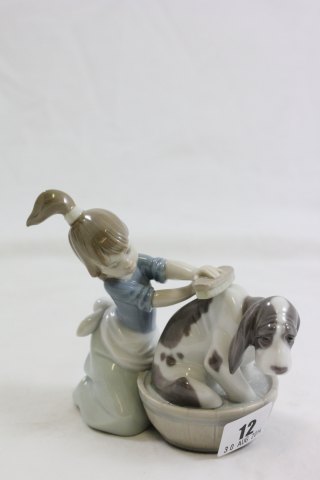A Lladro Figure of a Girl Washing a Dog
