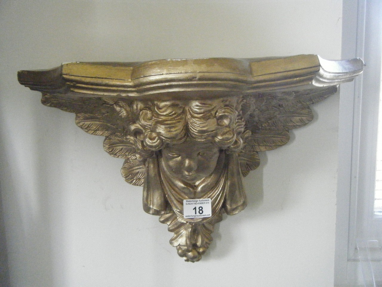 Parcel shelf modeled as a Cherub, gilt decorated on plaster, some minor condition issues