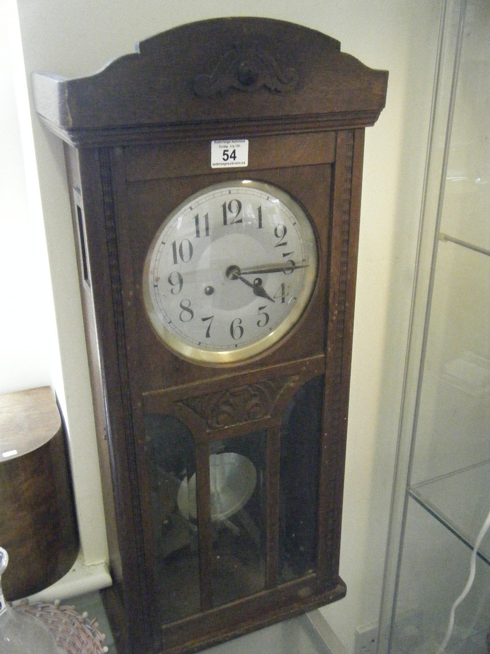 1920`s oak wall clock with an 8 day movement striking on a gong 8"" silver dial above a exposed