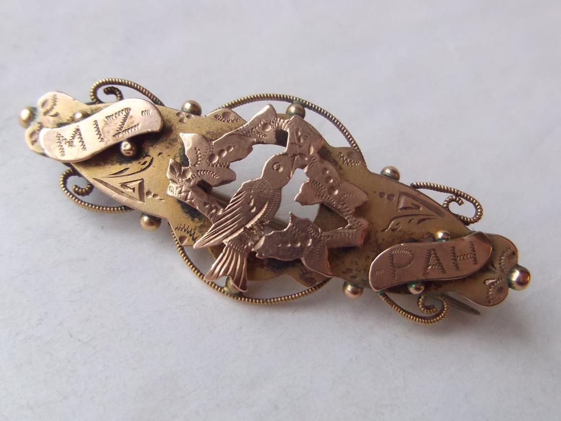 A Mizpah Victorian 9ct brooch decorated with a bird