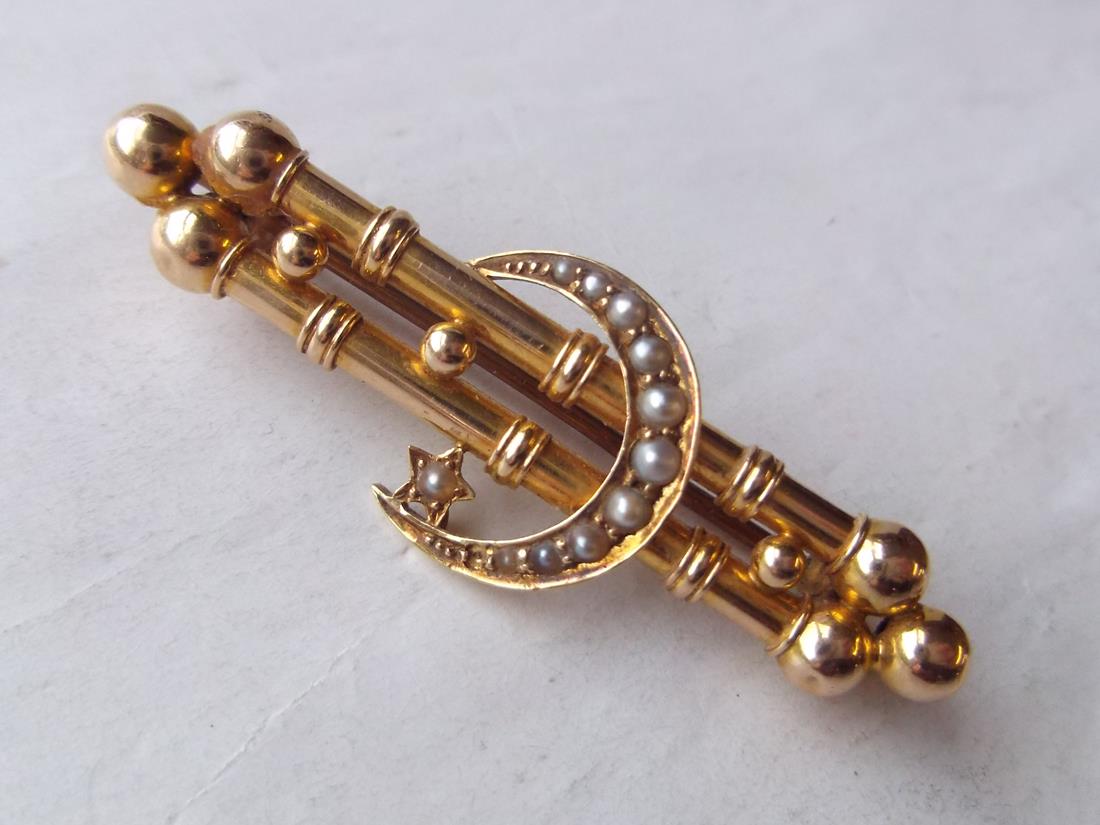 Pearl set crescent with star on a 15ct bar brooch