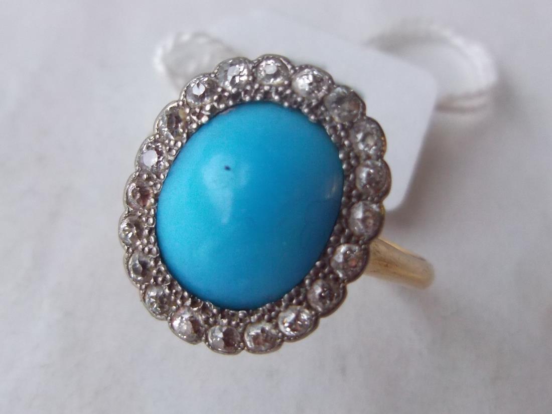 Turquoise ring with diamond border in gold mount