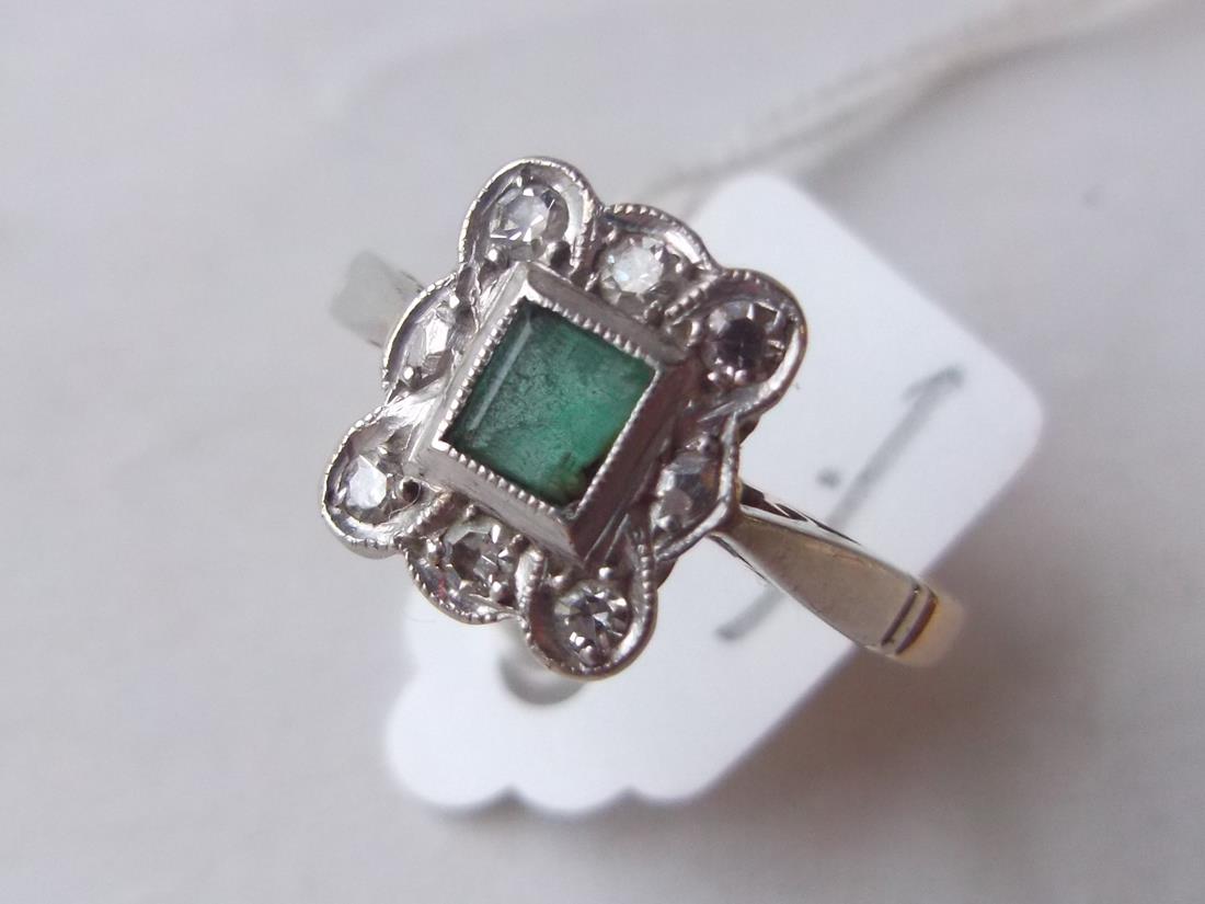 An emerald and diamond 10 stone ring in 18ct and  platinum