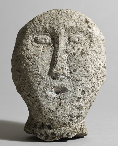 Circa 500BC to 500AD Iron Age. Irish stone head. Limestone; broken at the base, lower part of mouth