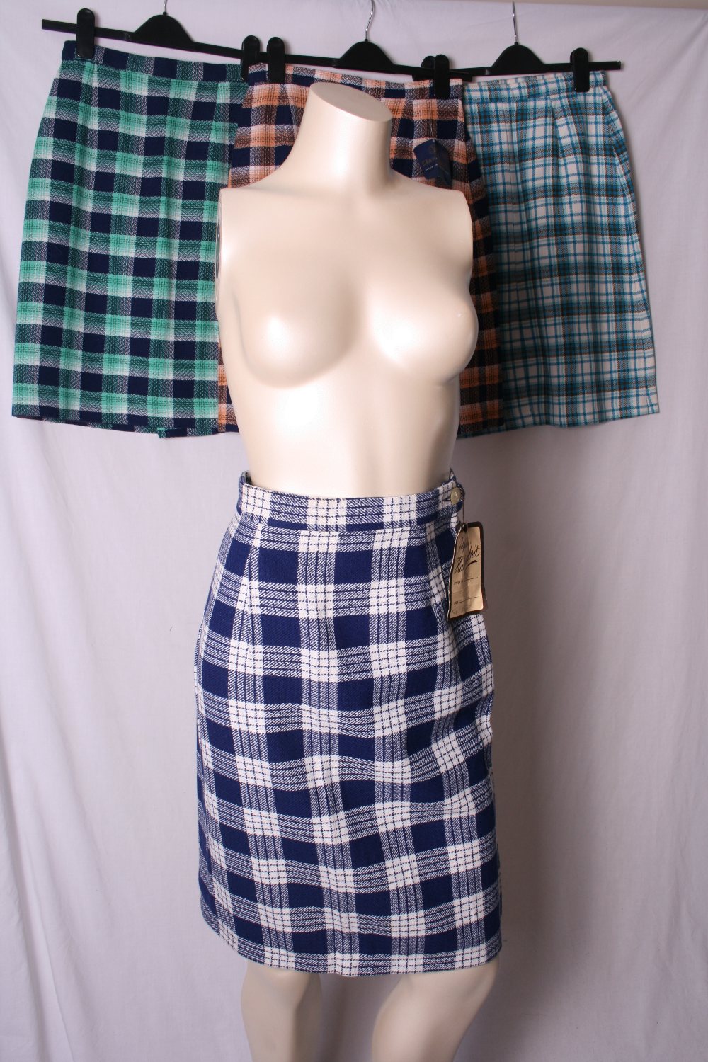 Group of four shop deadstock wool straight skirts of quality Scottish weave, (4)  Excellent