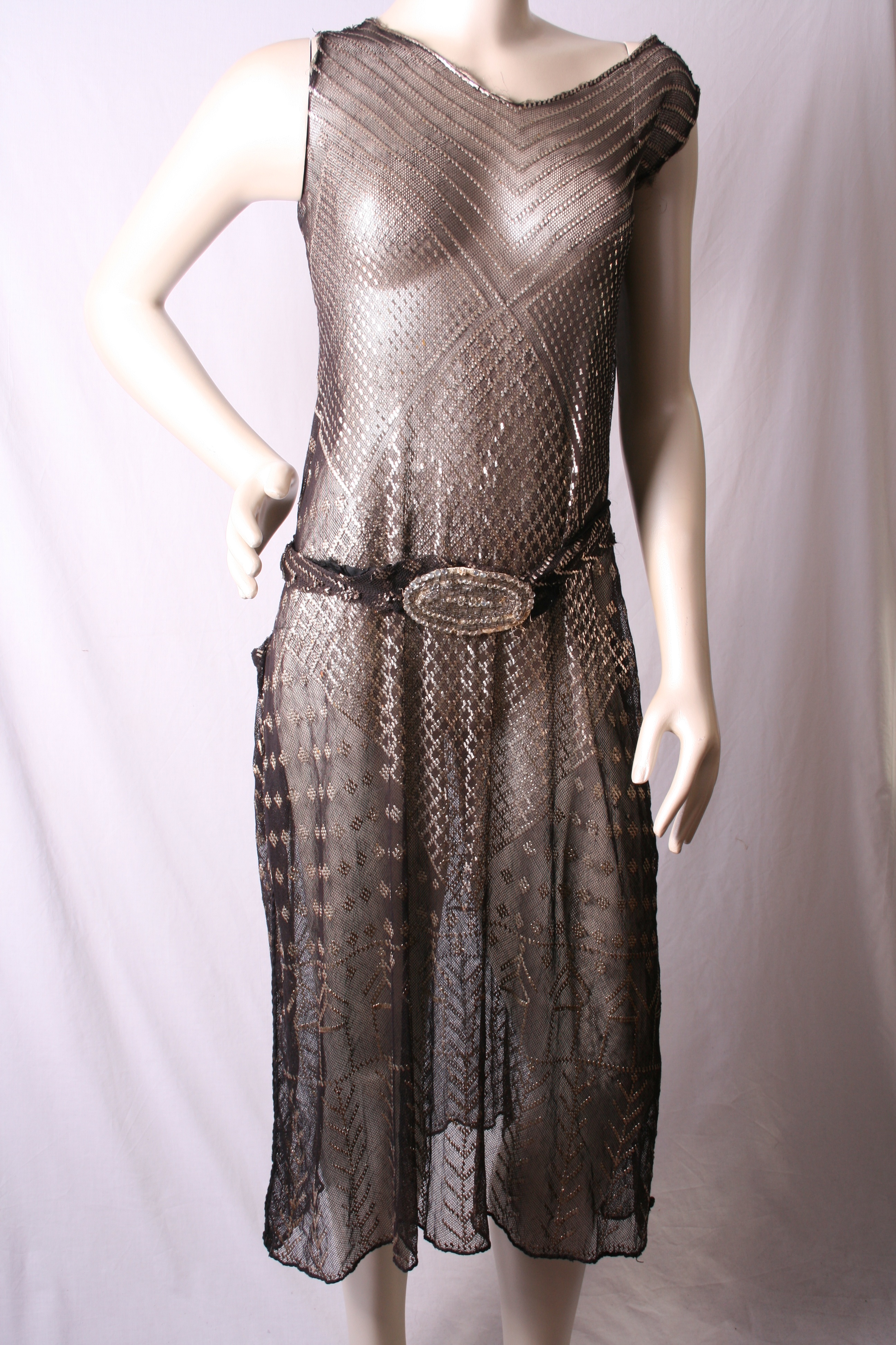1920s dress having extensive metallic mesh work forming a large central diamond design and with a