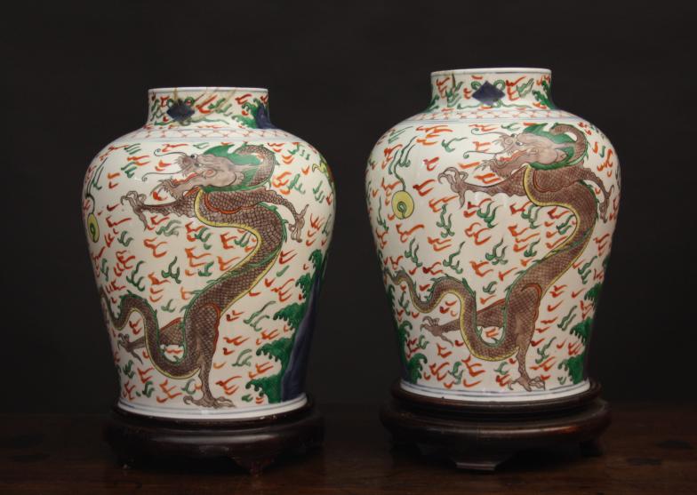 A Pair of Wacai Jars (A/F). Both decorated with celestial dragons amidst wispy flames chasing a