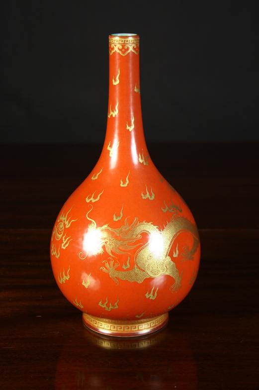 A Chinese Bottle Vase.  The globular body having a long narrow neck, decorated with gilded scaly