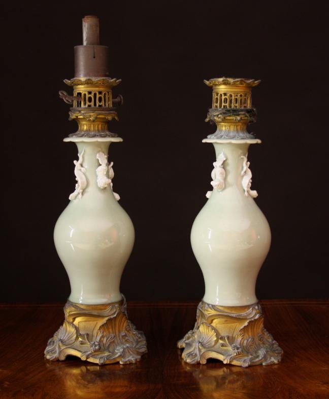 A Pair of 19th Century Green Celadon Oil Lamps with gilt bronze mounts.  The ceramic baluster bodies