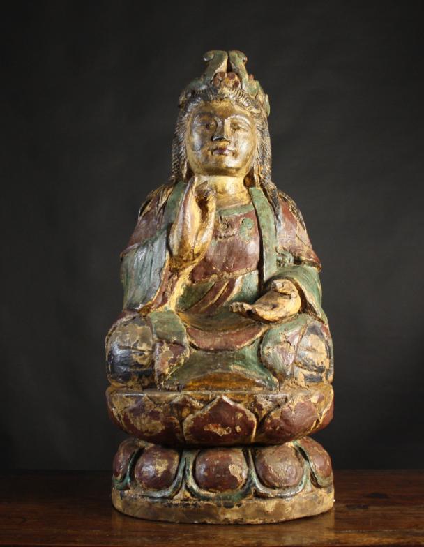 A Polychromed Wood Carving of Buddhistic Female Figure sat on a lotus, 30 ins (76 cms) high.