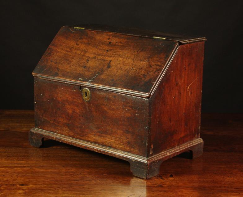 A Georgian Mahogany Desk Box.  The hinged slope front rising to reveal two drawers and a box