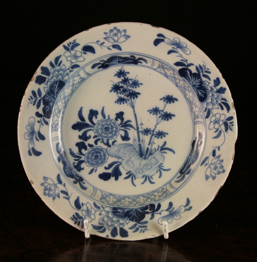 An 18th Century Liverpool Delft Blue & White Plate decorated in the chinoiserie style with flowers