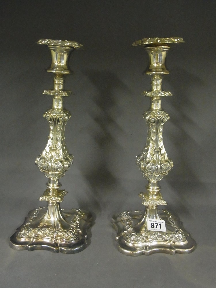 A pair of large Sheffield plate candlesticks in the Georgian style 
Condition report: One requires