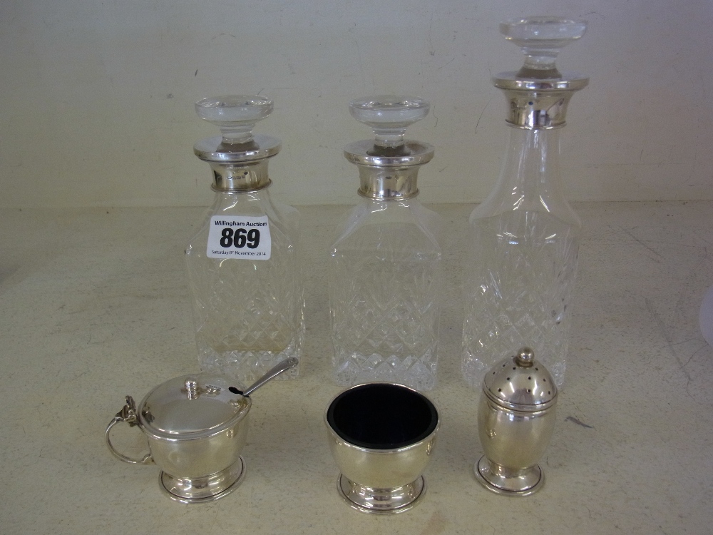 A silver cruet and three silver rimmed condiment bottles
Condition report: Hinge broken to