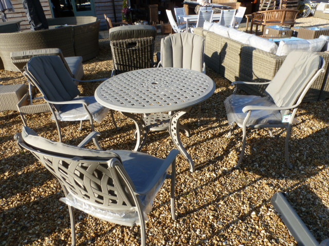 A Bramblecrest Naples table and four chairs - with cushions