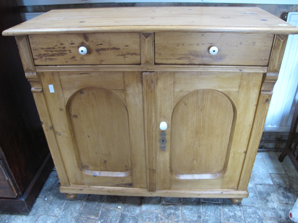 A waxed pine dresser base with two drawers over two cupboard doors - Height 97cm x Width 107cm
