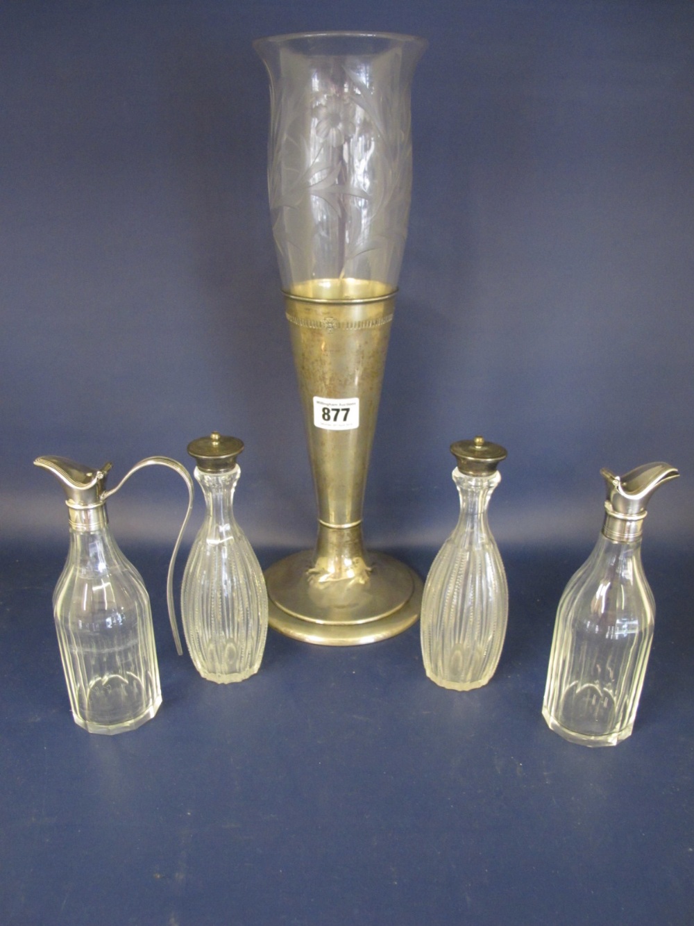A pair of oil bottles with plated tops - one handle missing, a pair of cruet bottles with silver