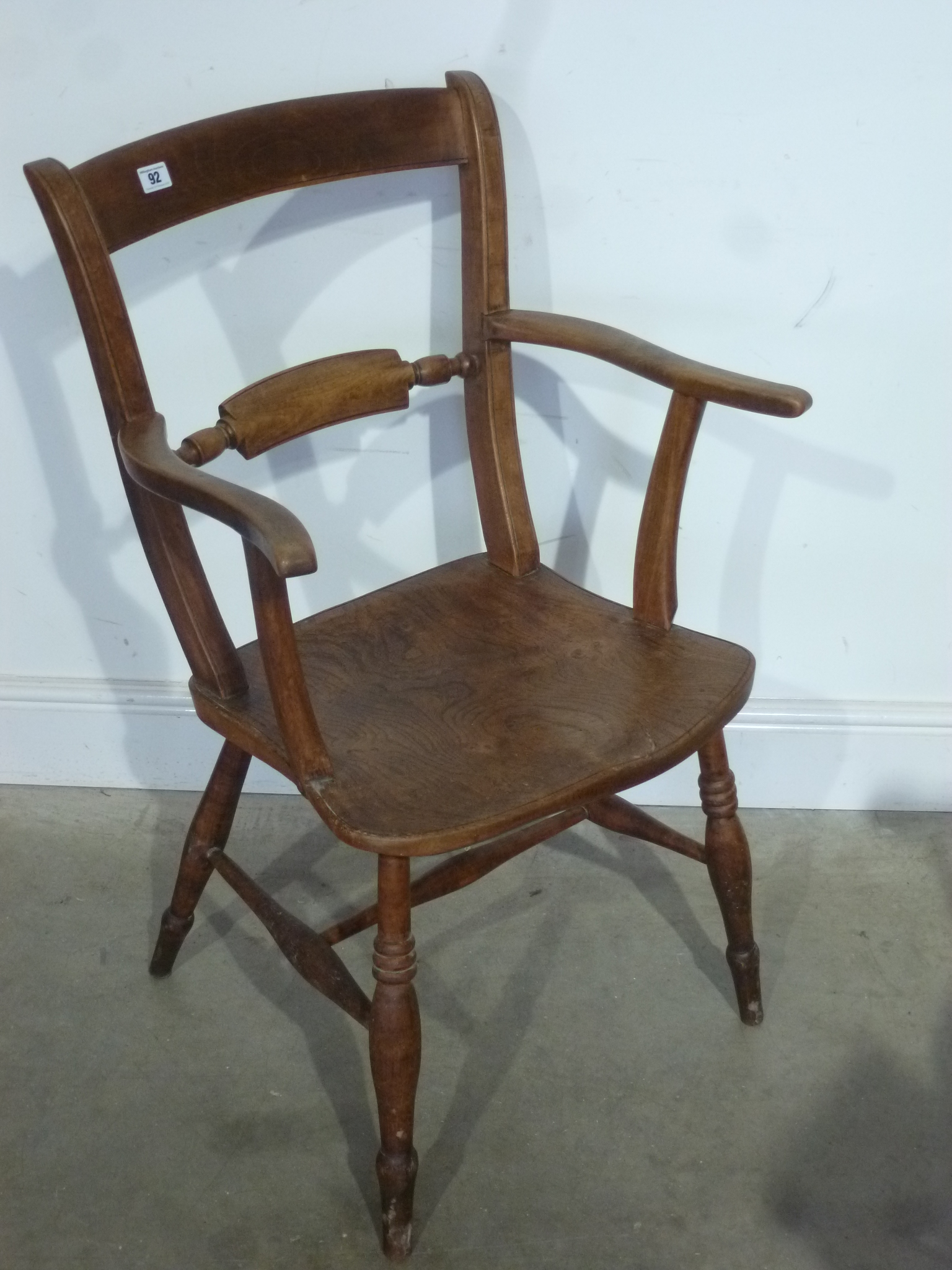 A 19th century ash and elm knife back elbow chair