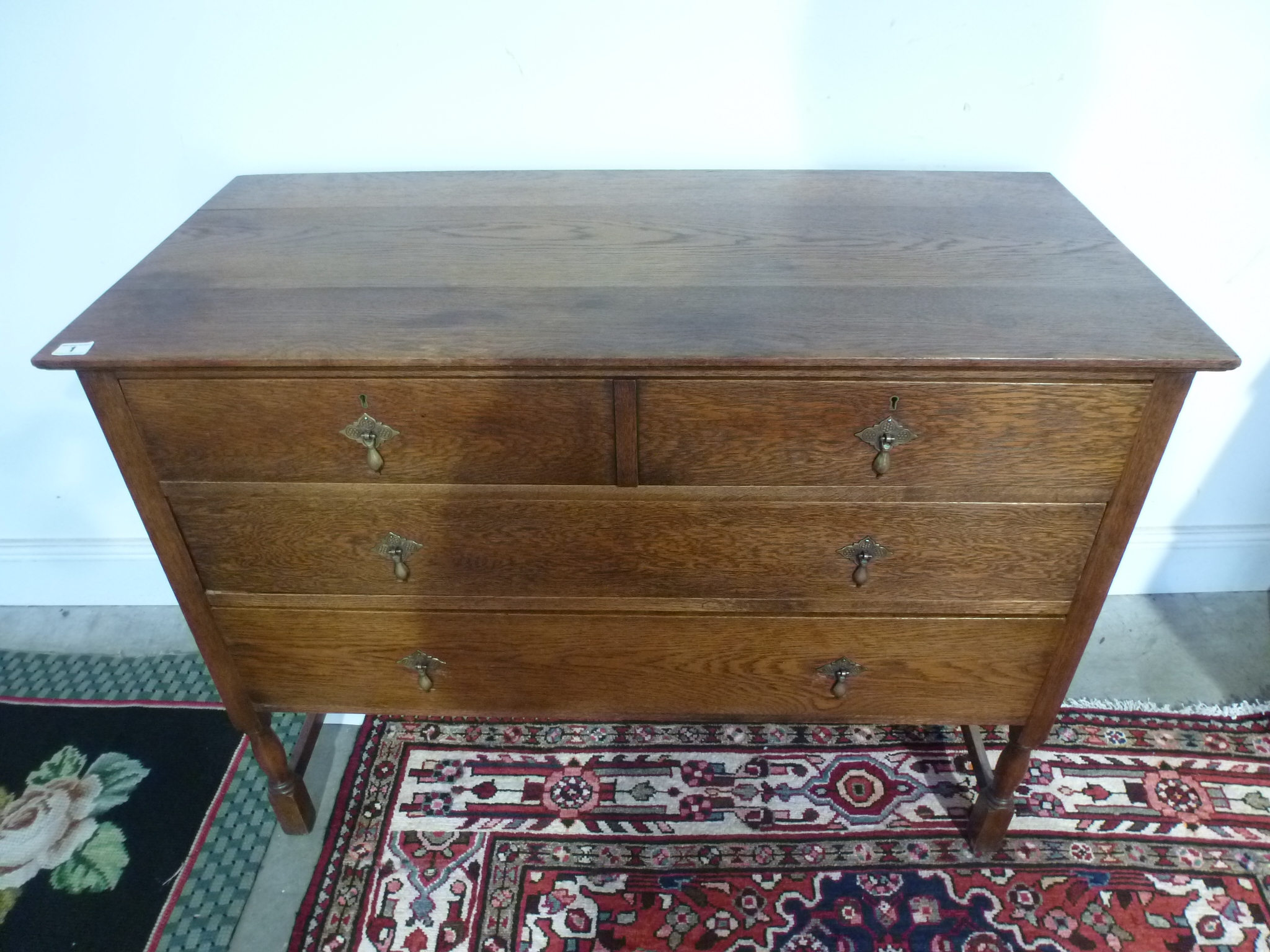 An oak chest of drawers with two short over two long drawers and a dressing table mirror - Width