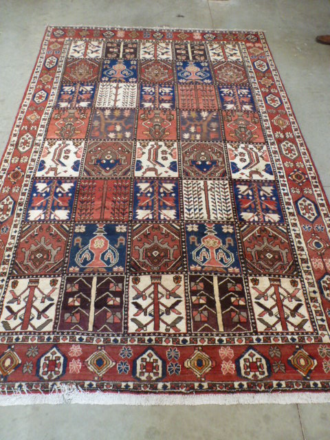 A red ground handmade Persian Heriz carpet - 3.00 m x 2.00 m