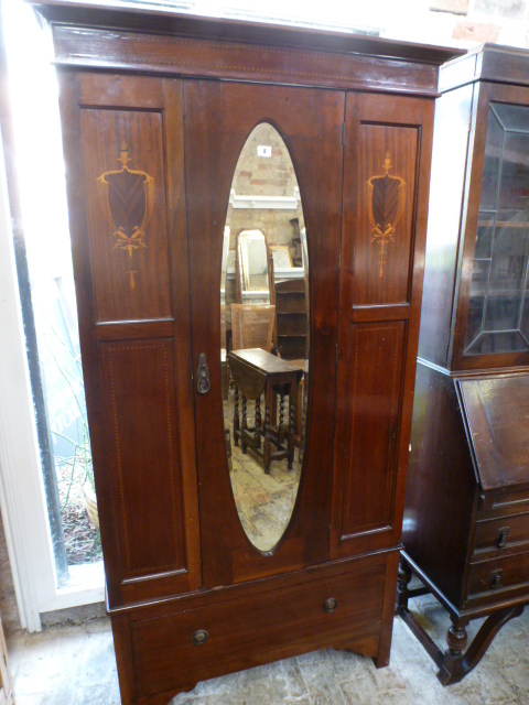 An Edwardian mahogany and inlaid single wardrobe