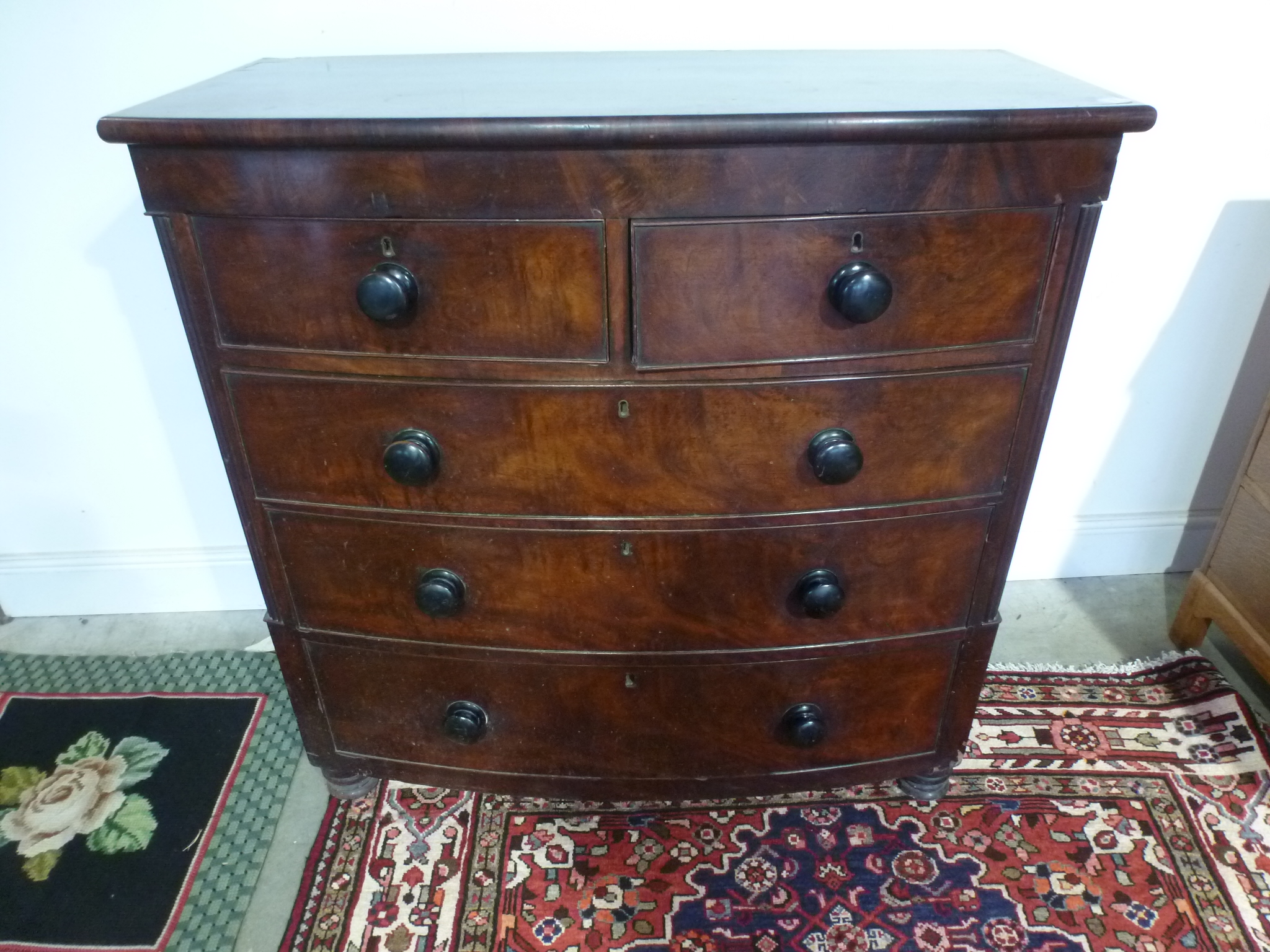 A 19th century mahogany bow front chest of drawers with two short over three long drawers